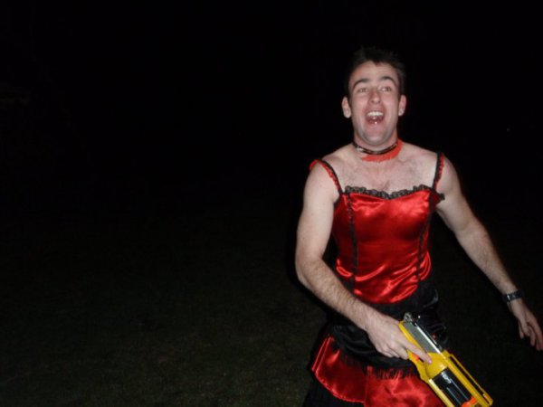 drunk man in a red dress wielding a Nerf Maverick